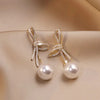 Pearl Earrings with a Shiny Gold Bow